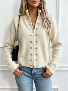 Close-up detail of women's cream knit zip cardigan featuring stylish metal button decorations.