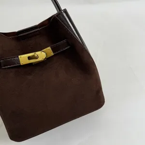 Brown suede bucket bag with luxury metal clasp closure, stylish daily shoulder handbag.