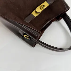 Brown suede leather handbag with retro gold metal turn-lock closure, stylish shoulder bag.