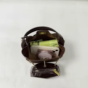 Retro brown bucket bag detail view showing large capacity and internal storage space layout.