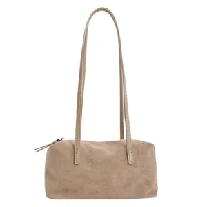 Detailed view of the soft suede texture and zipper closure on the chic shoulder bag.