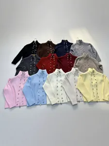 Women's knitted zip-up cardigan sweater with elegant metal button decoration and cozy high collar.