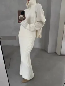 Detail view of women half-zip knit sweater and long skirt set, soft ribbed fabric.