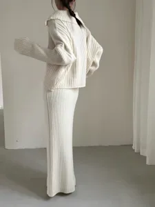 Beige ribbed knitwear set featuring a half-zip collar sweater and a long matching skirt.
