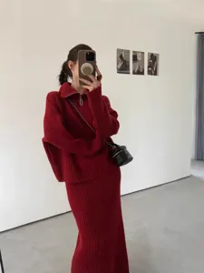 Detail shot of women's cozy ribbed knit sweater and midi skirt set in rich red color.