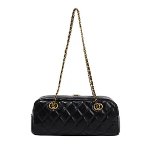 Detailed view of the vintage black quilted bowling bag featuring luxurious gold chain strap.
