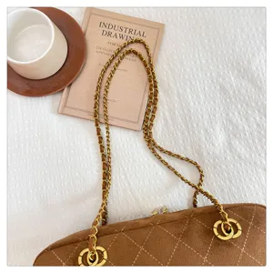 Brown quilted chain shoulder bag, vintage suede crossbody bag with metal strap details.