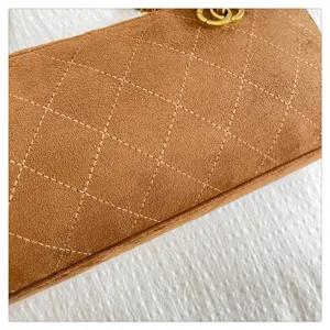 Brown suede quilted shoulder bag featuring elegant diamond stitching and gold chain detail.