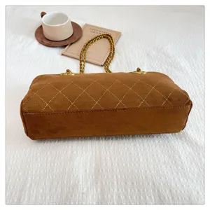 Brown vintage quilted chain shoulder bag, elegant suede baguette purse for women.