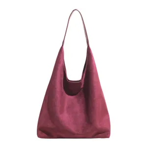 Burgundy suede hobo bag detail shot, showing soft texture and minimalist everyday design.