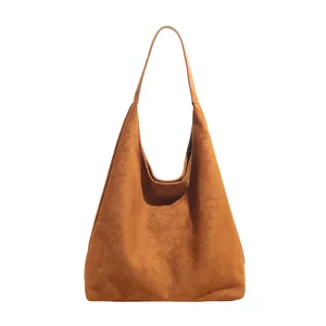 Brown suede hobo bag detail shot, soft texture close-up, elegant minimalist shoulder strap.