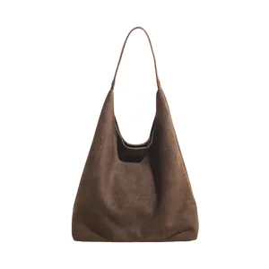 Detailed view of brown suede hobo bag showing soft texture and minimalist commuter design.