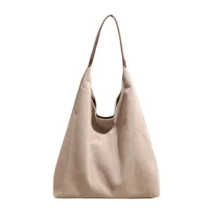 Close-up detail of the vintage suede hobo shoulder bag with soft texture and brown handle.