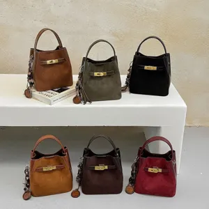 Classic suede bucket bag with metal lock closure, vintage style shoulder handbag for women.