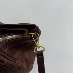 Detail view of brown retro suede tote bag featuring durable gold hardware and secure metal clasp.