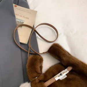 Brown faux fur plush shoulder bag detail with metal lock closure and soft texture close-up.