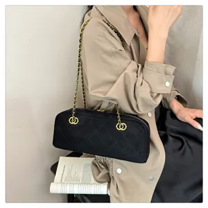 Black quilted suede baguette shoulder bag with gold chain strap, vintage bowling purse for women