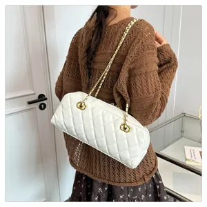 Elegant white quilted bowling bag with chic chain strap, vintage style baguette shoulder bag for women