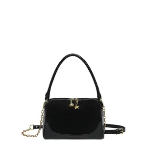 Black chic pillow shoulder bag with metal chain strap and star charm detail fashion accessory