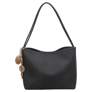 Minimalist large capacity black shoulder tote bag with chic double straps and hanging charm.