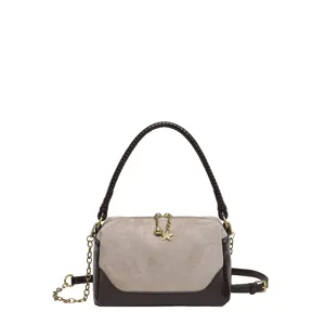 Detailed view of the stylish two-tone shoulder bag with metallic chain and cute star pendant.