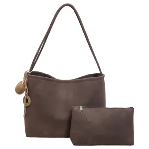 Brown minimalist tote bag detail showcasing texture, matching pouch and stylish charm pendant.