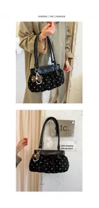 Detail view of the stylish polka dot shoulder bag with bow and pearl pendant charm.