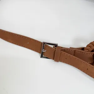 Nahaufnahme des braunen gewebten Lederhandtaschenriemens mit silberner Schnalle.