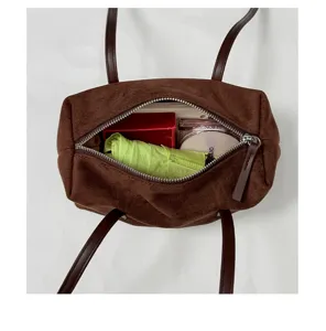 Vintage brown suede pillow bag, chic underarm shoulder bag with long strap for daily commute.