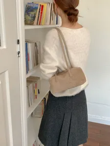 Minimalist suede shoulder bag with dual straps, elegant underarm bag for daily commute.