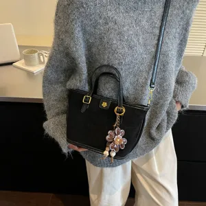 Stylish black shoulder tote bag for women, versatile daily handbag with chic flower charm.