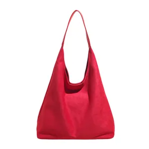 Red suede hobo shoulder bag detail, featuring soft fabric and minimalist daily commuter design.