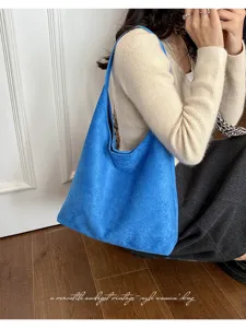 Minimalist blue suede hobo shoulder bag for women, versatile vintage casual commuter tote bag.
