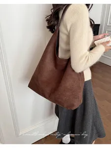 Close up of brown vintage suede hobo shoulder bag, stylish casual everyday commuting bag.