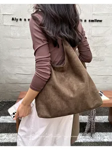 Brown suede hobo shoulder bag detail view showing casual commuter style and large capacity.
