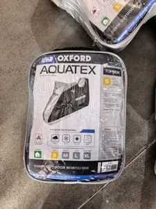 Detailed view of Oxford Aquatex motorcycle cover packaging showing size S and features.