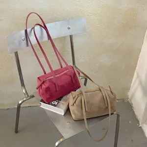 Vintage suede shoulder bag for women, chic pillow handbag with long strap for daily commute.