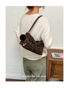 Leopard print shoulder bag with plush ball detail, vintage casual handbag for women.