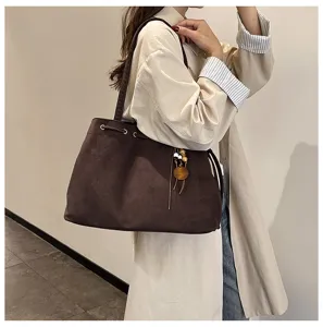 Detailansicht der braunen Wildleder-Tasche, lässige Schultertasche für Pendler und stilvolle Mode.