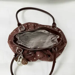 Brown polka dot tote bag with bow accent and pearl pendant for daily fashion casual use