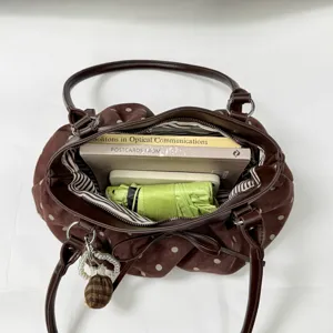 Brown polka dot tote bag inner capacity detail showing spacious storage with cute bow decor.