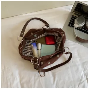 Detailed top view of the brown polka dot canvas tote bag showing inner capacity and design.