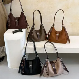 Vintage suede shoulder bag for women, slouchy hobo tote with buckle and charm detailing.
