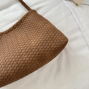 Braune gewebte Handtasche Detail, klassisches Flechtmuster Design, hochwertiges Material.