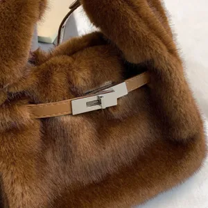 Brown plush handbag with leather strap and metal lock closure, soft faux fur shoulder bag.