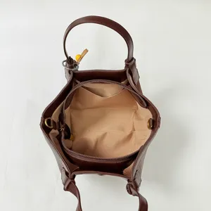 Brown leather tote bag interior view, minimalist casual shoulder bag with spacious compartment.