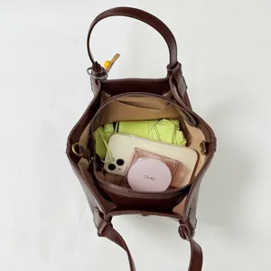 Brown vintage style tote bag with top handle, spacious interior for women daily commute use.