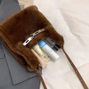 Chic brown plush shoulder bag for women, cozy faux fur tote with stylish metal lock and strap.