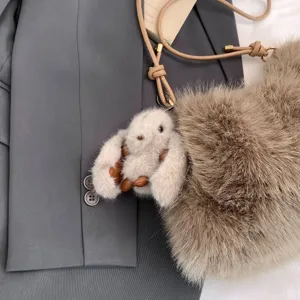 Fluffy plush shoulder bag with cute rabbit pendant, soft faux fur texture, stylish detail shot.