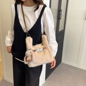 Detailed shot of trendy plush shoulder bag with cute bunny ears and metal lock buckle design.